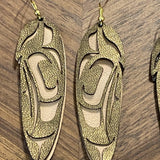 Close up of feather earrings by indigenous artist leather 5