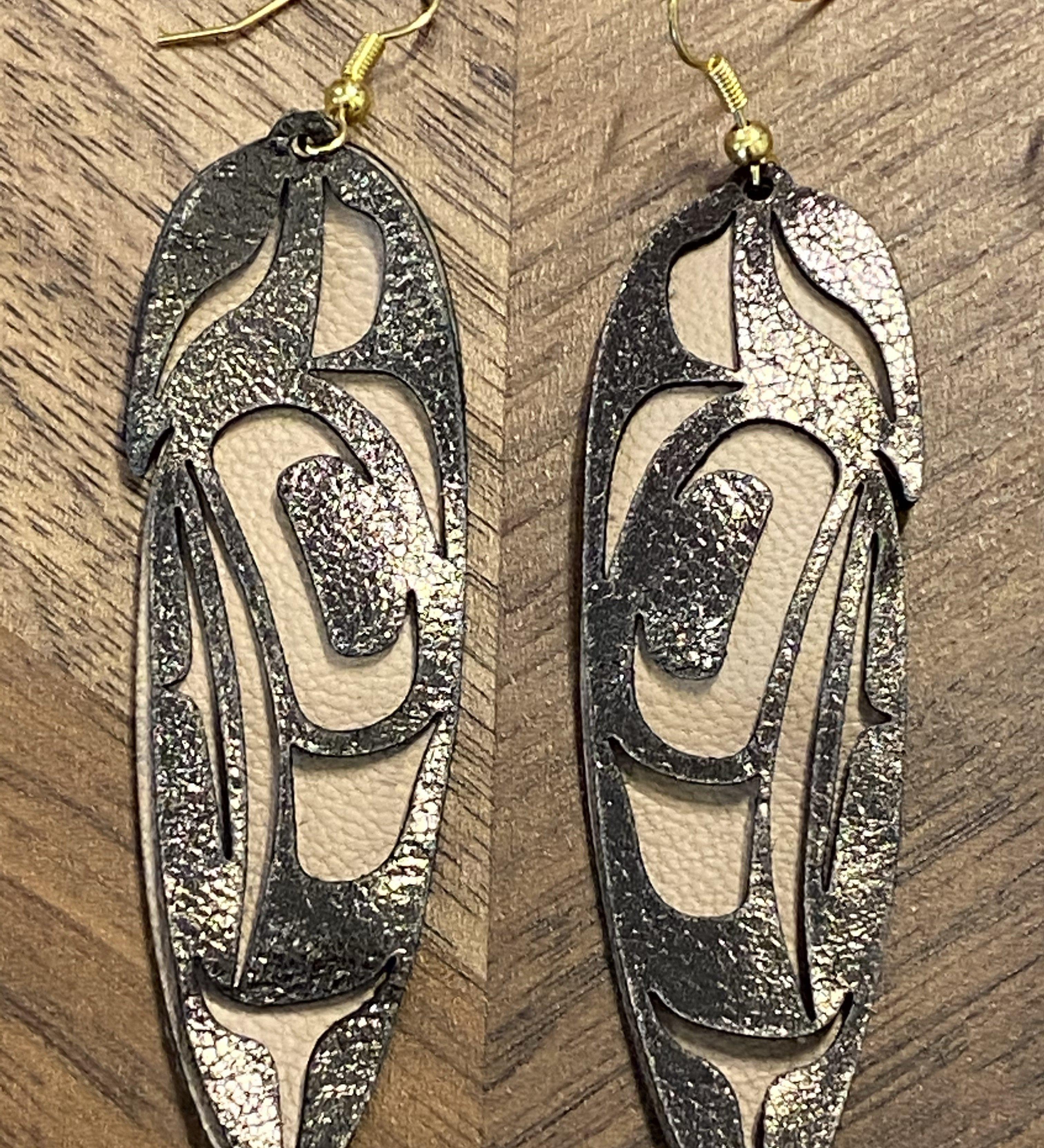 Close up of feather earrings by indigenous artist leather 7