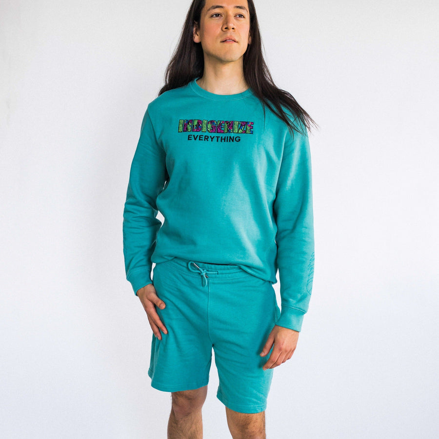 Model wearing Organic cotton shorts in teal by indigenous artist