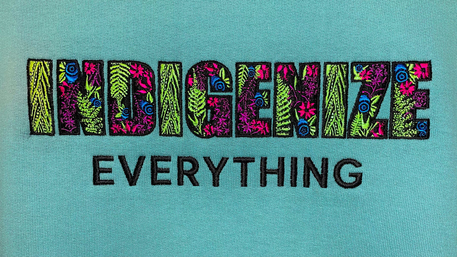 Closeup of Indigenize everything sweatshirt by indigenous artist
