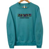 Indigenize everything top in teal by indigenous artist