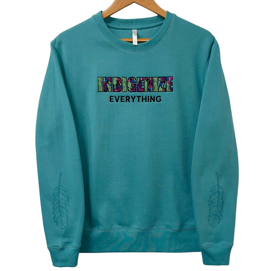 Indigenize everything top in teal by indigenous artist