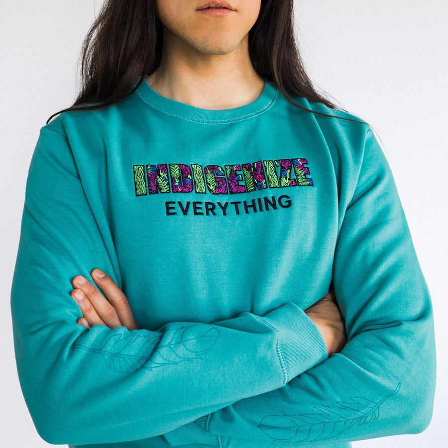 Closeup model wearing Indigenize everything sweatshirt by indigenous artist