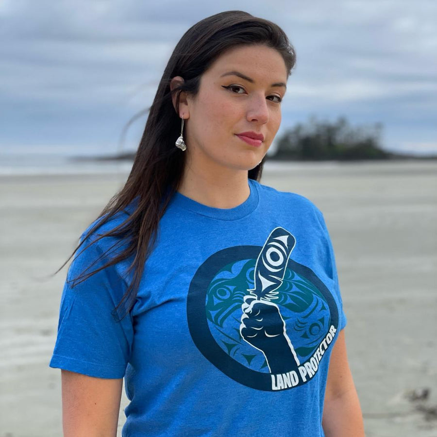 Model wearing Land Protector Unisex T shirt by indigenous artist Andy Everson