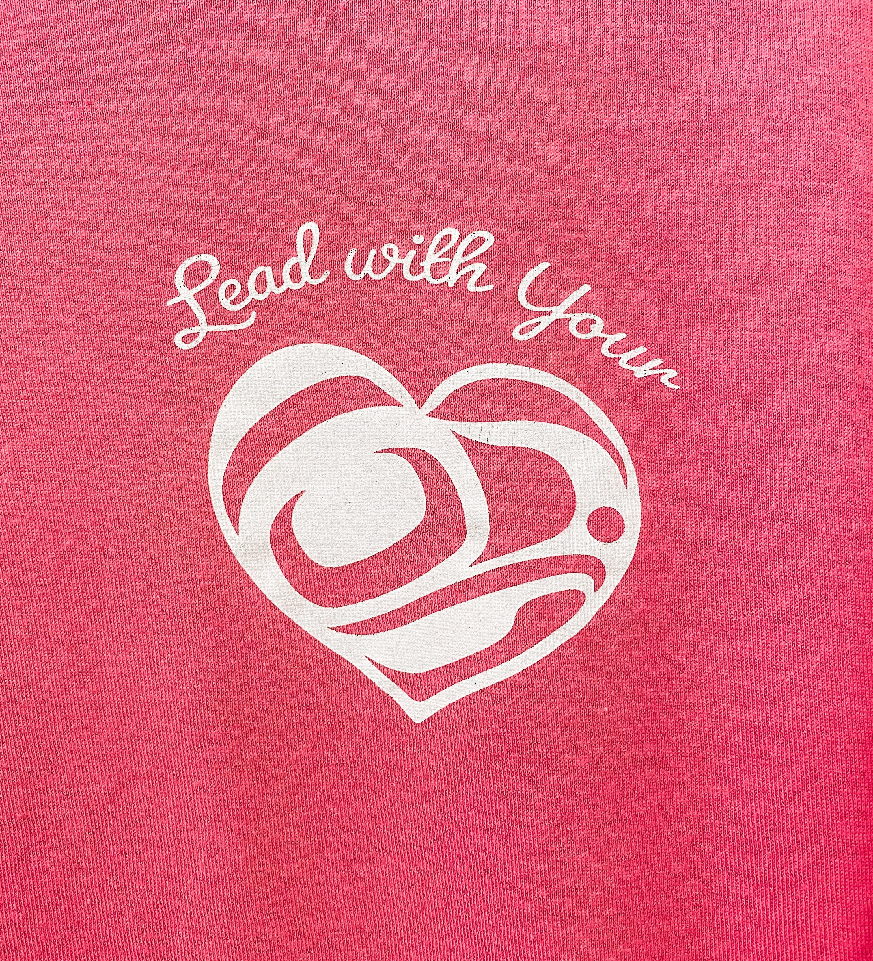 Close up of Lead With Your Heart Unisex T shirt  by indigenous artist in dark pink