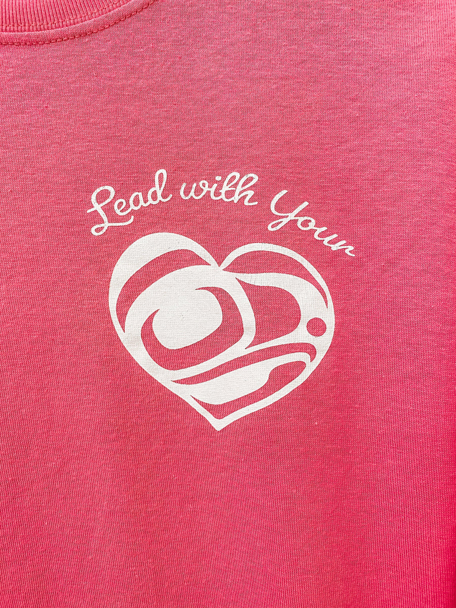 Close up of Lead With Your Heart Unisex T shirt  by indigenous artist in dark pink