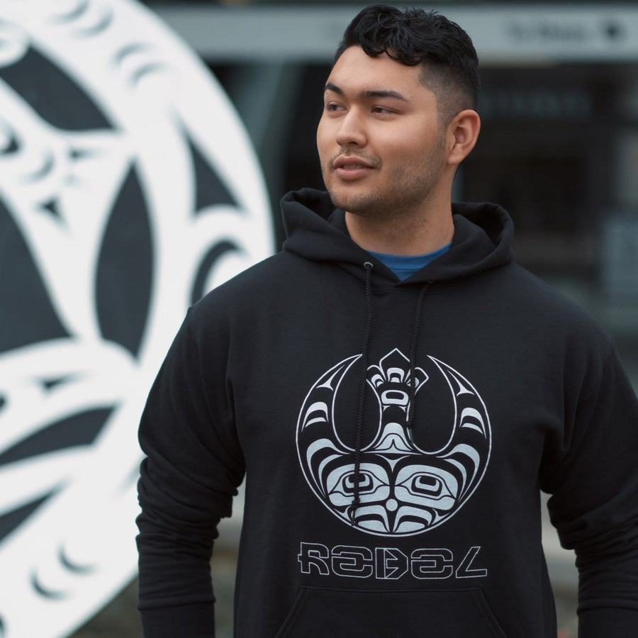 Model wearing Unisex hoodie called Indigenous Rebellion by indigenous artist Andy Everson