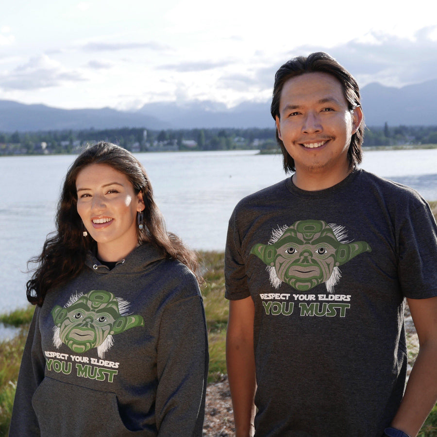 Models wearing unisex hoodie called elder by indigenous artist