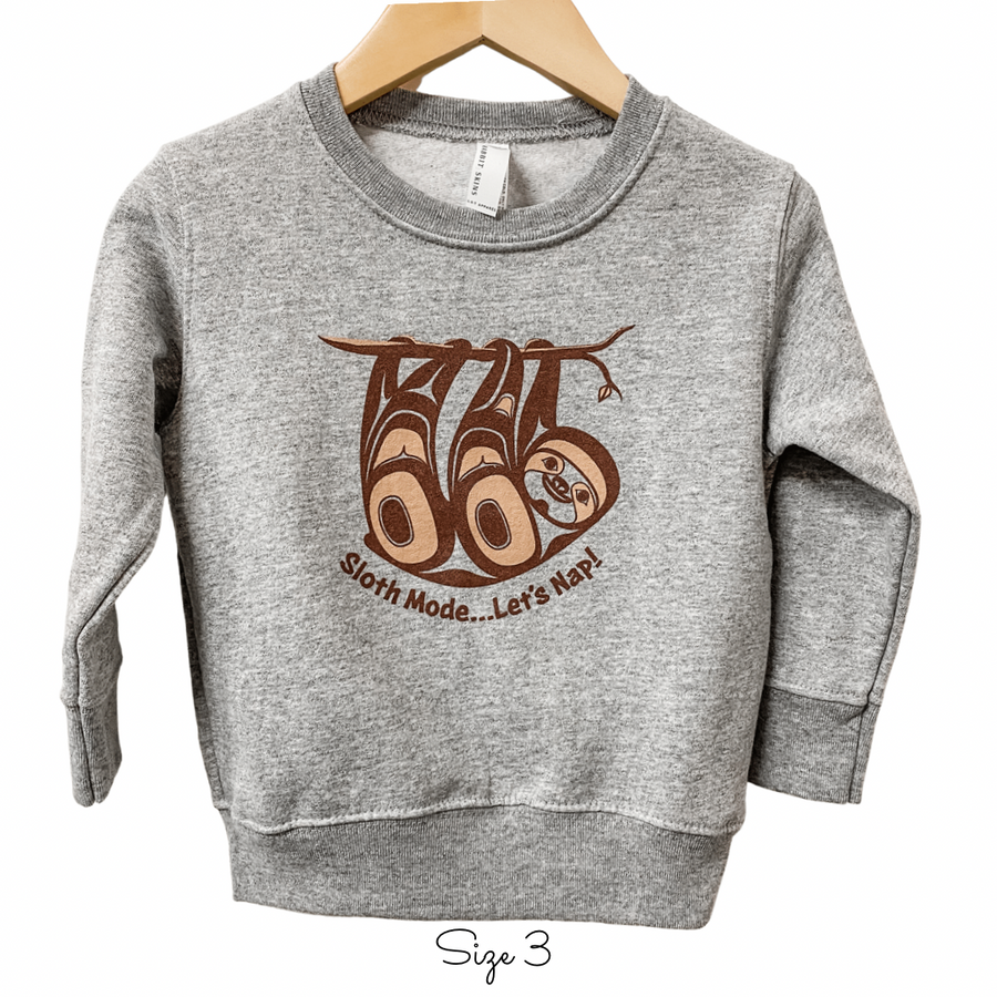 Front view of Native apparel kids sweatshirt featuring the sloth by Indigenous artist 3