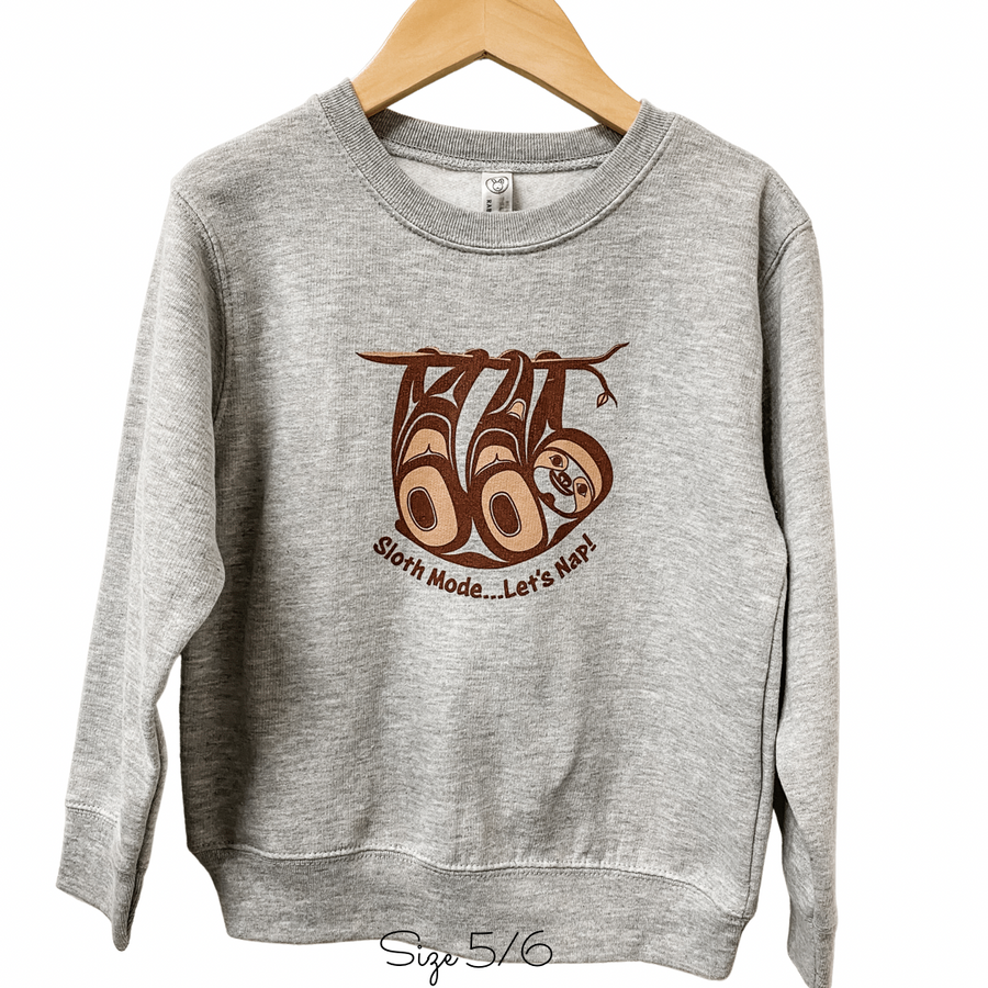 Front view of Native apparel kids sweatshirt featuring the sloth by Indigenous artist