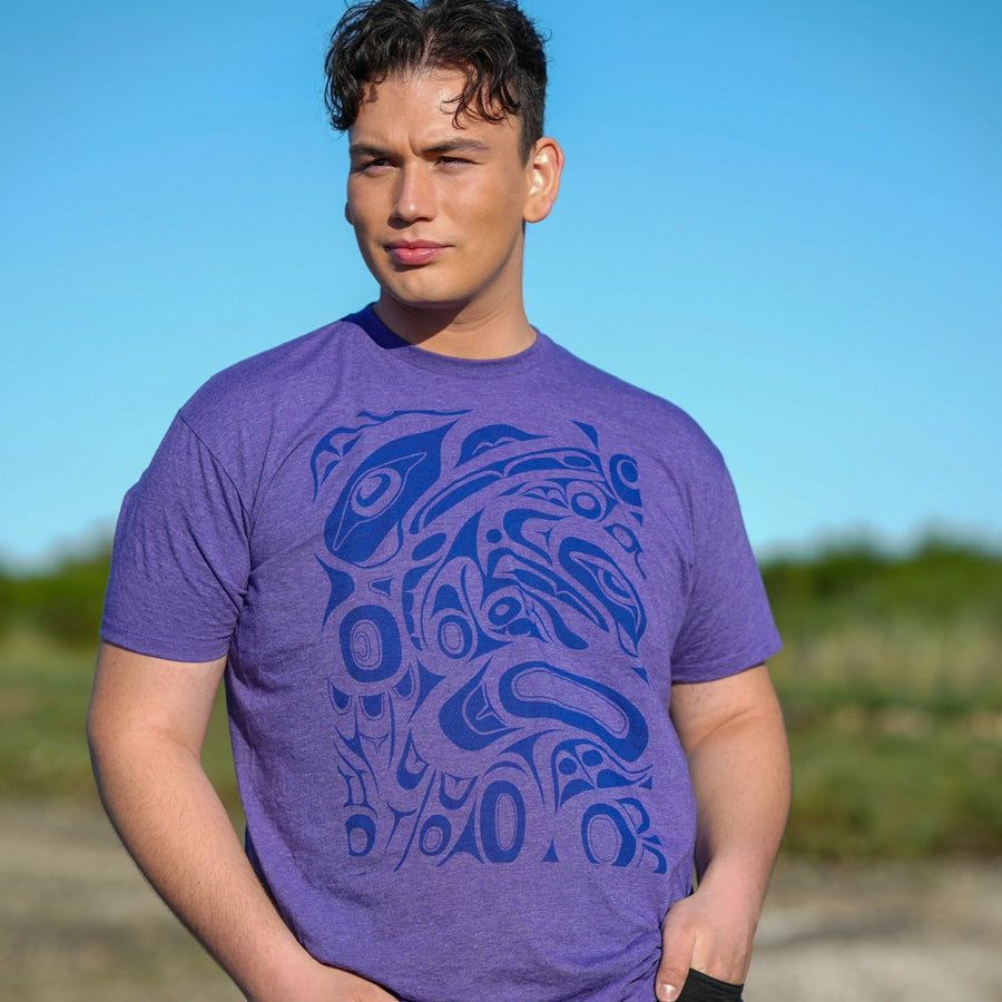 Model wearing unisex t-shirt raven and eagle motif by indigenous artist in purple