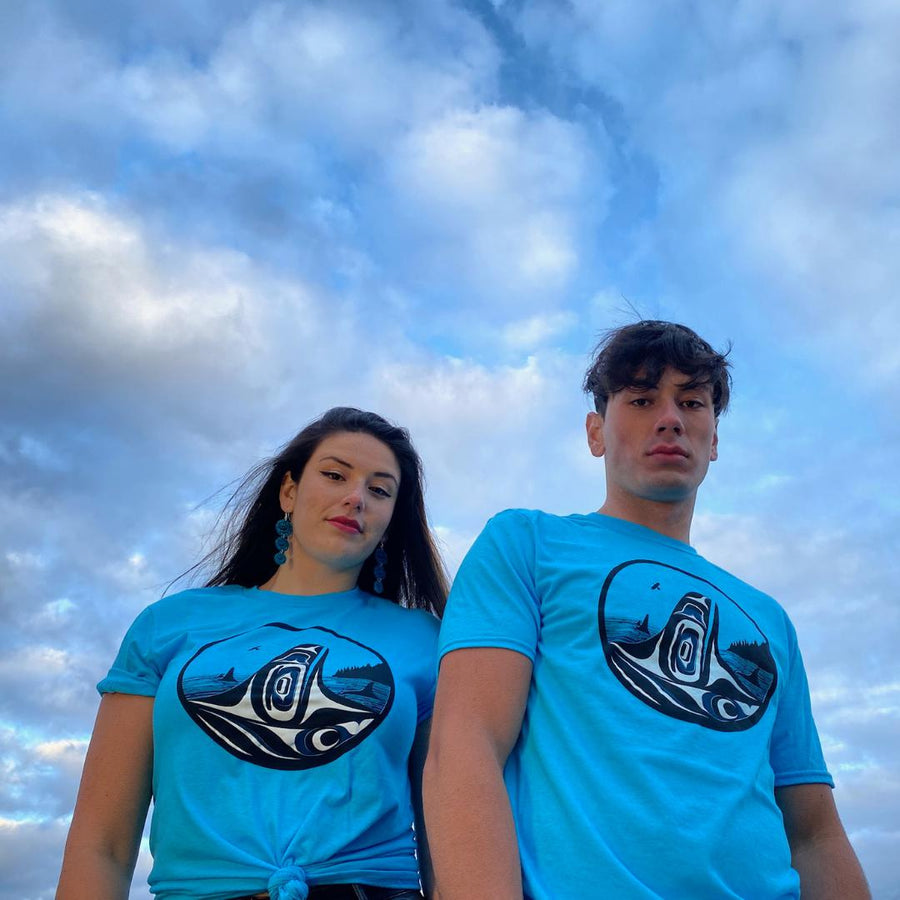 Models wearing unisex t-shirt featuring Raven-Fin Killer Whale by indigenous artist