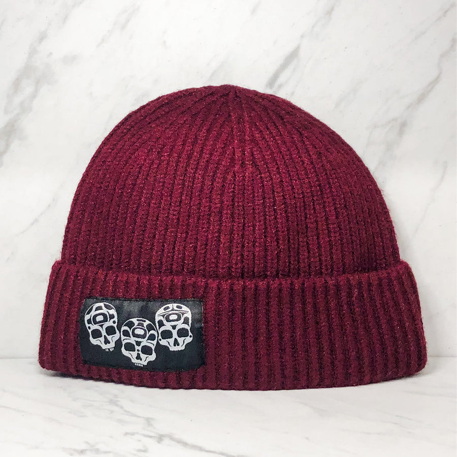 Wool winter hat with embroidered skull design by Haida artist Jesse Brillon