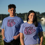 Models outside wearing unisex t-shirt featuring a sloth by indigenous artist