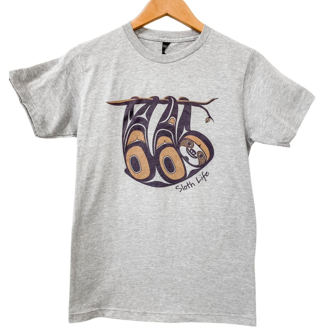 Front view of unisex t-shirt featuring a sloth by indigenous artist in white