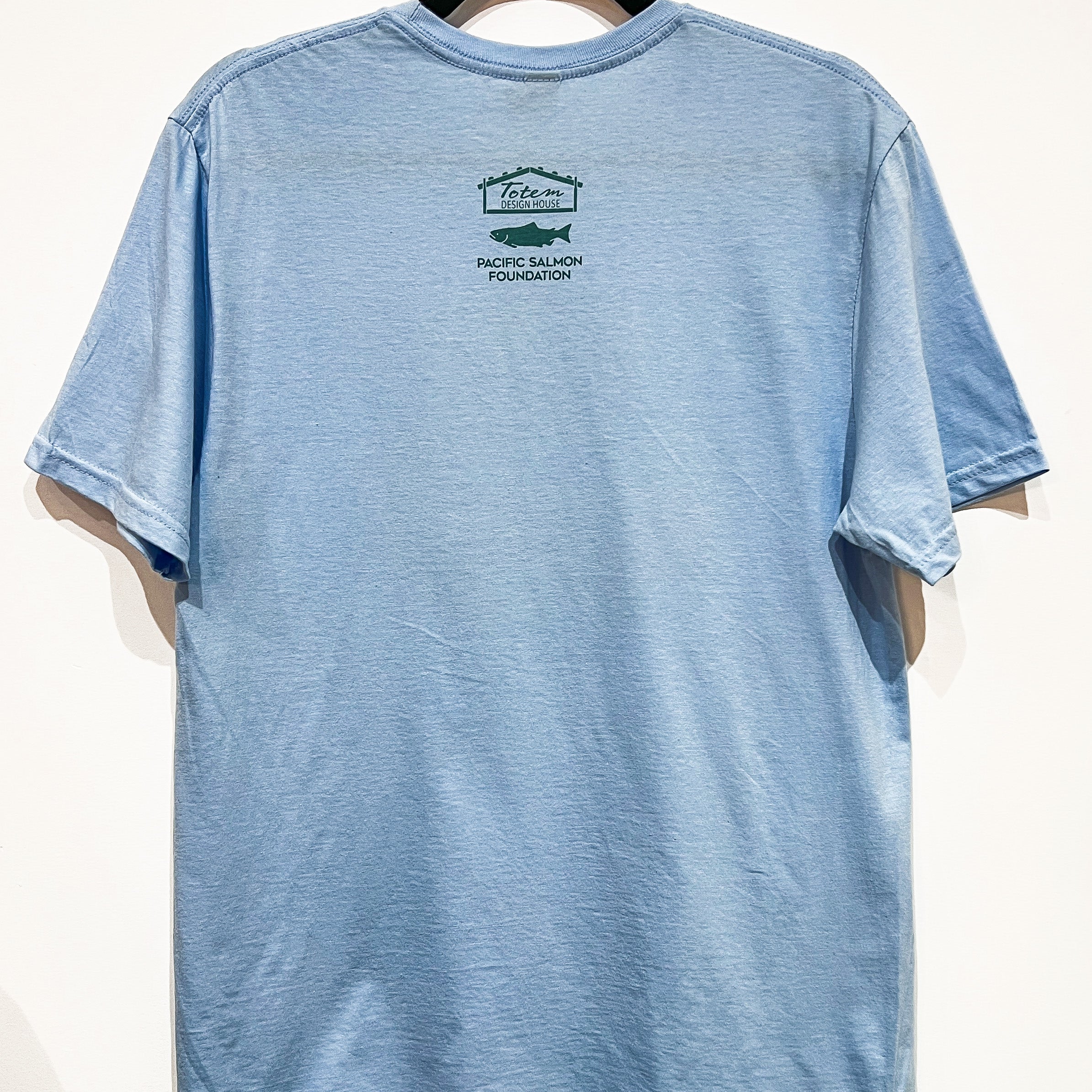 Back view of Native apparel called The Return unisex t-shirt by Indigenous artist