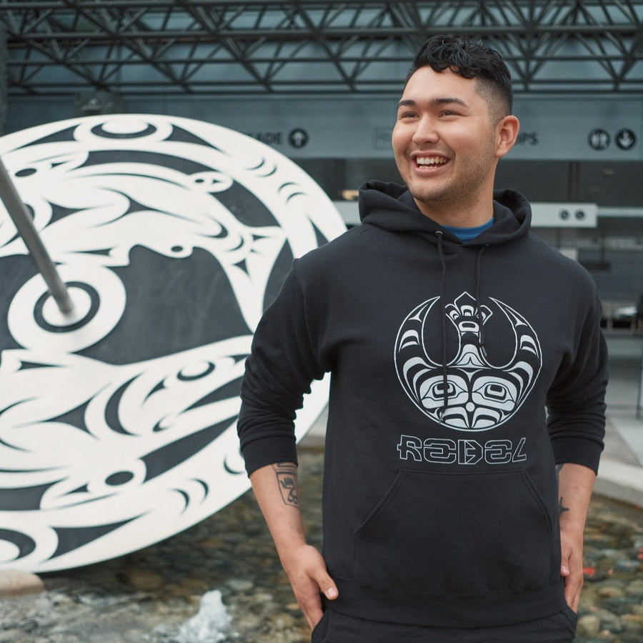 Model wearing Indigenous Rebellion Hoodie Unisex by indigenous artist Andy Everson