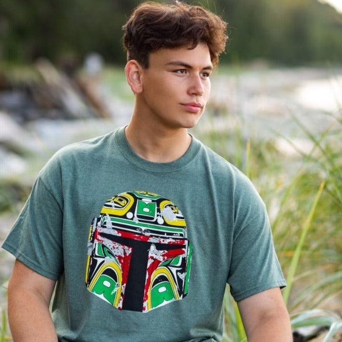 Male model wearing Resilience Unisex T-Shirt by indigenous artist Andy Everson