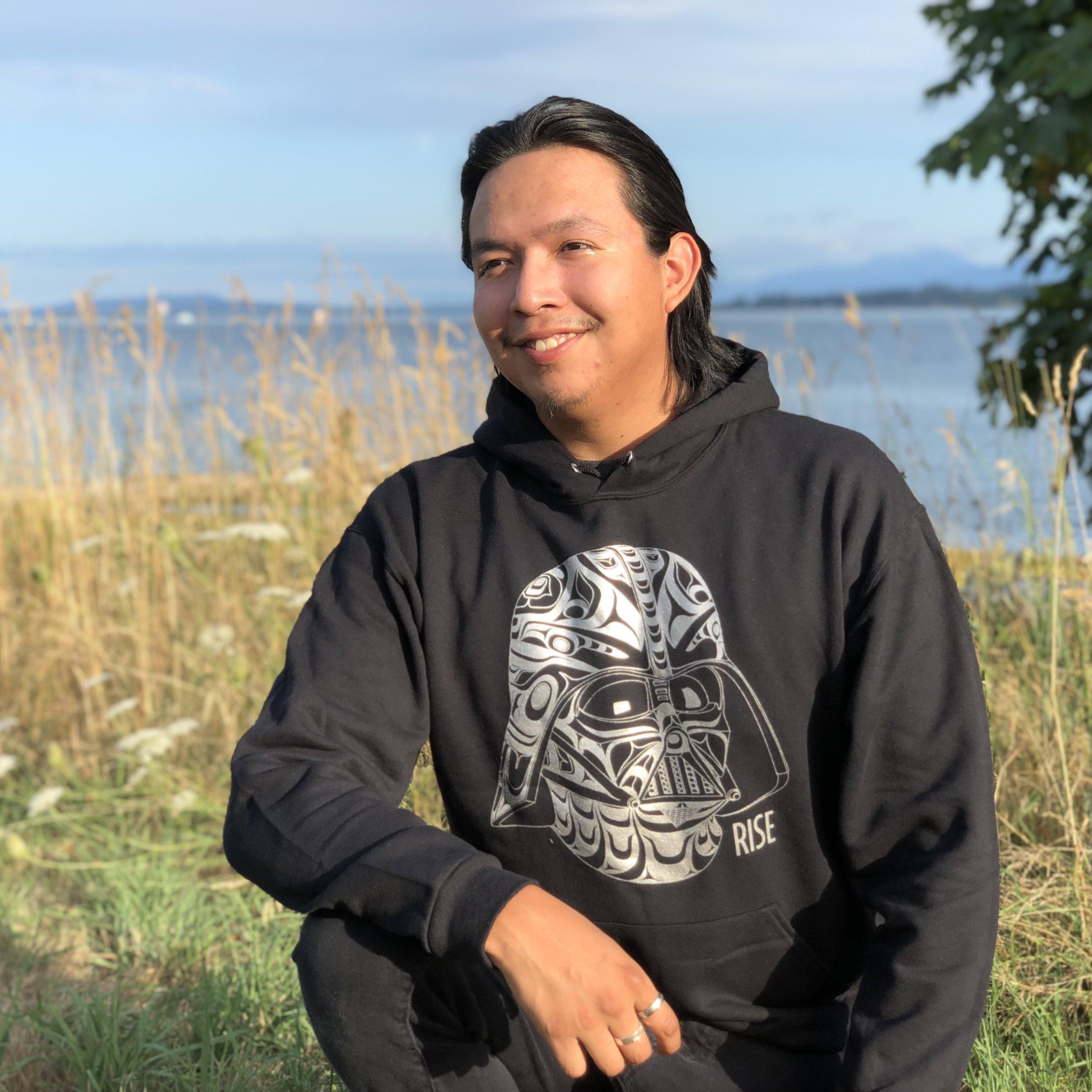 Model wearing Unisex hoodie called Rise by indigenous artist Andy Everson