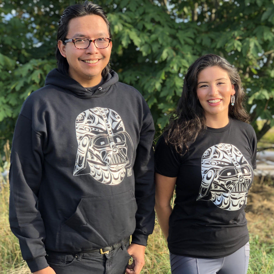 Two models wearing Unisex T-shirt called Rise by indigenous artist Andy Everson