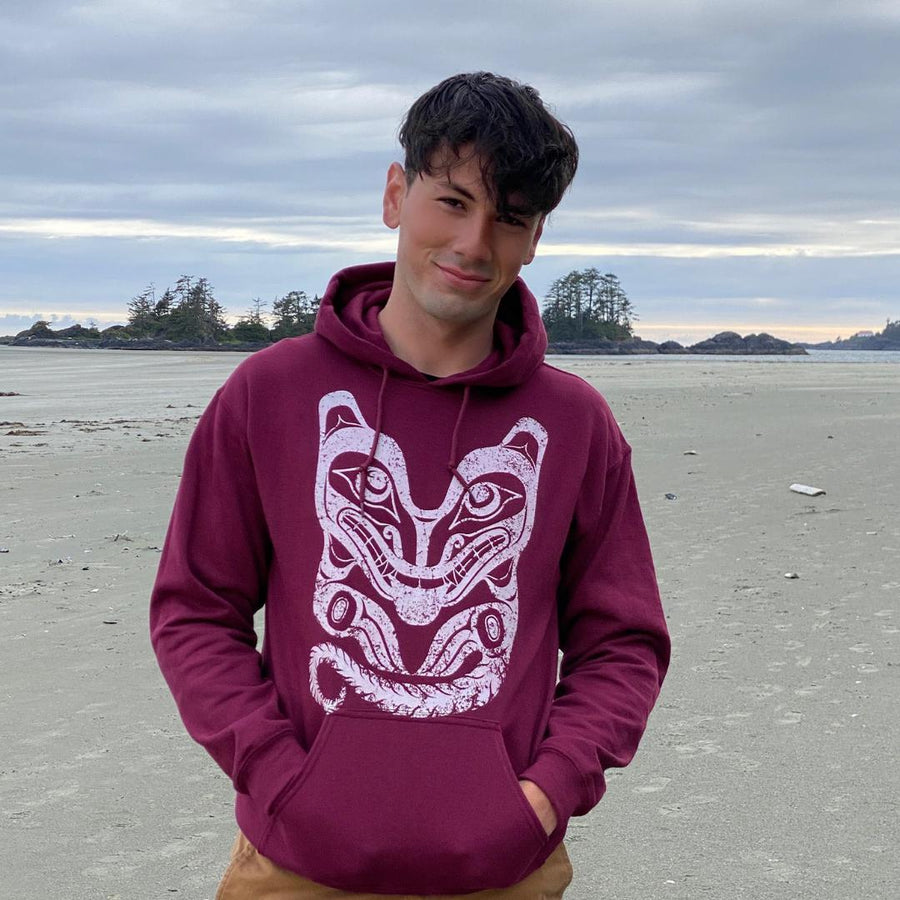 Model wearing Unisex hoodie called wolf by indigenous artist in maroon