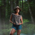 Model wearing cap-sleeve bamboo top by indigenous artist featuring a bear