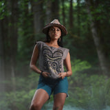 Model wearing cap-sleeve bamboo top by indigenous artist featuring a bear