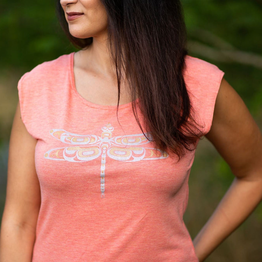 Model close up outside wearing womens hoodie created by indigenous artist featuring a dragonfly