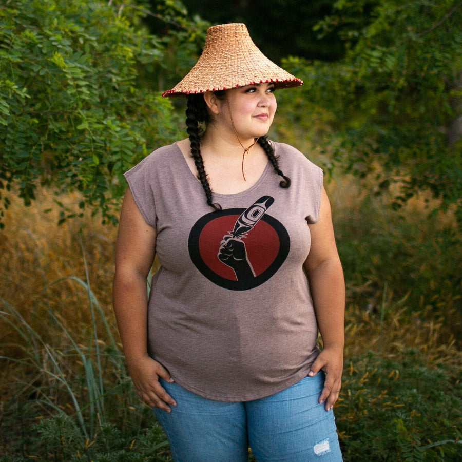 Model wearing womens top created by indigenous artist called idle no more