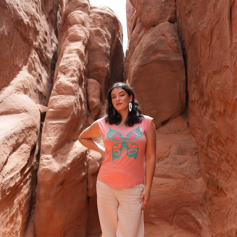 Model wearing womens top created by indigenous artist featuring the butterfly