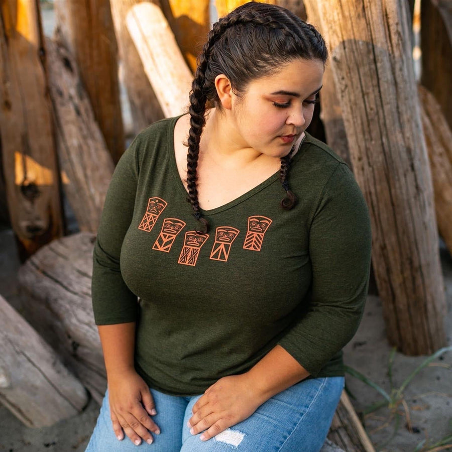 Model sitting outside wearing womens organic cotton top by indigenous artist called coppers