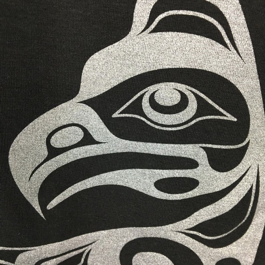 Model outside wearing womens organic cotton top by indigenous artist featuring eagle closeup