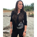 Model at beach wearing womens organic cotton top by indigenous artist featuring eagle in black