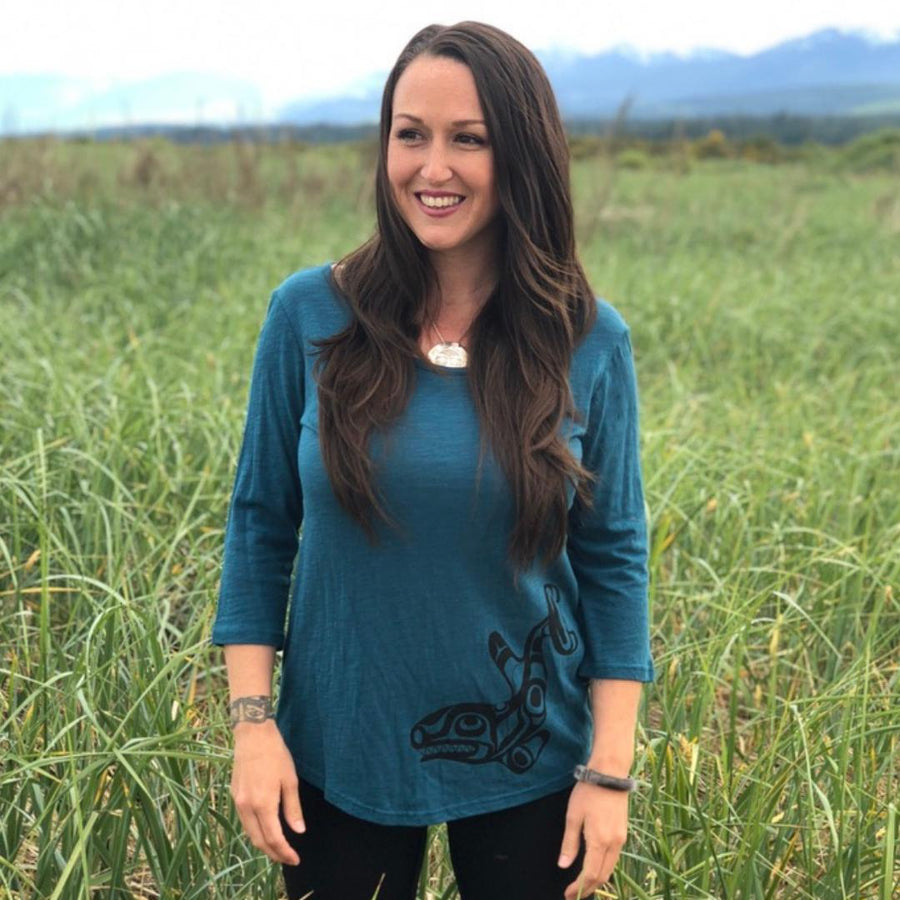 Model outside wearing womens organic cotton top by indigenous artist featuring the killer whale 2