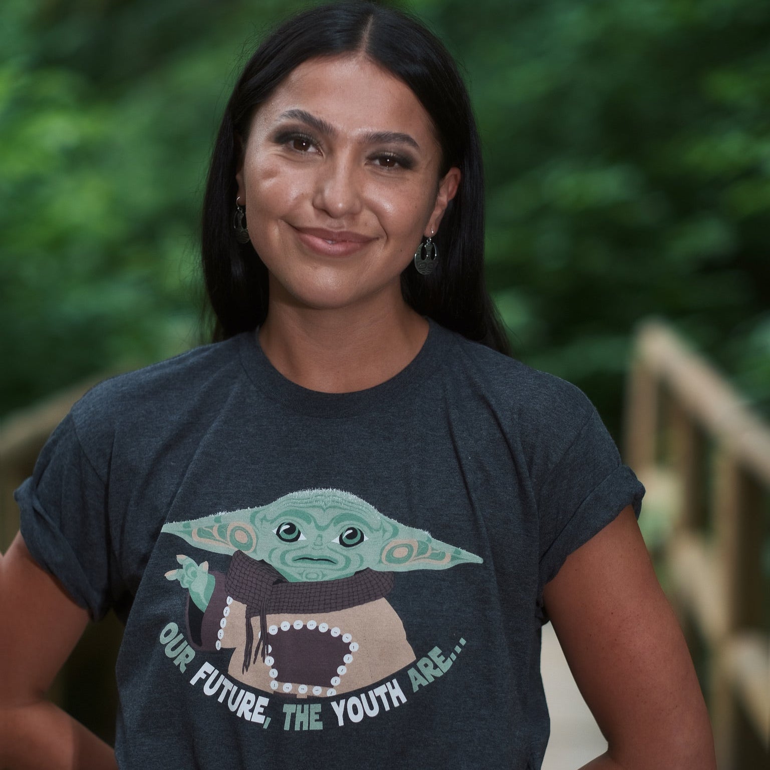Model outside wearing unisex T-shirt called Youth by indigenous artist Andy Everson
