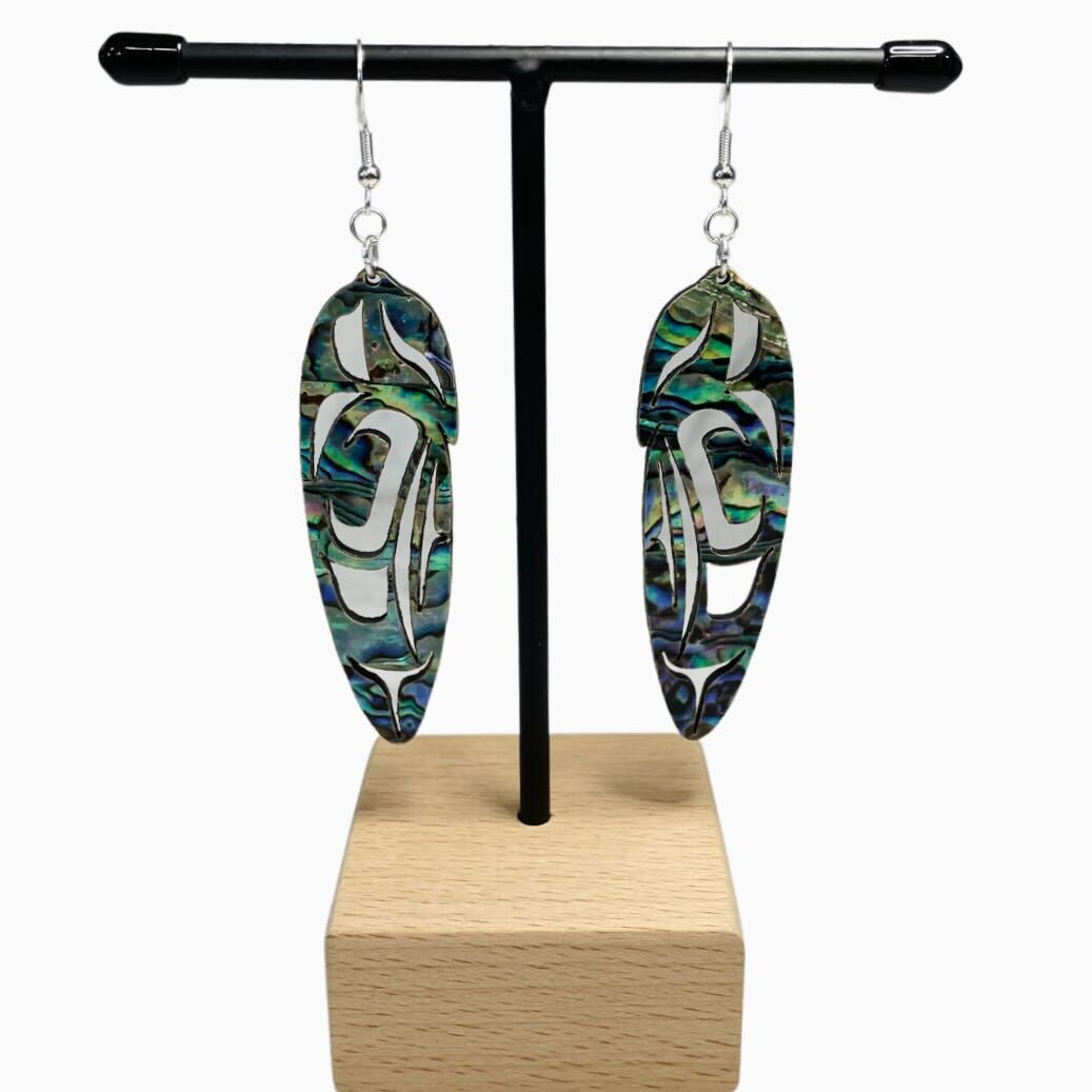 Close up up of abalone feather earrings by indigenous artist