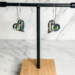 Close up up of abalone heart earrings by indigenous artist