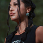 Close up up view of ancestral skull earrings by indigenous artist sterling silver 2