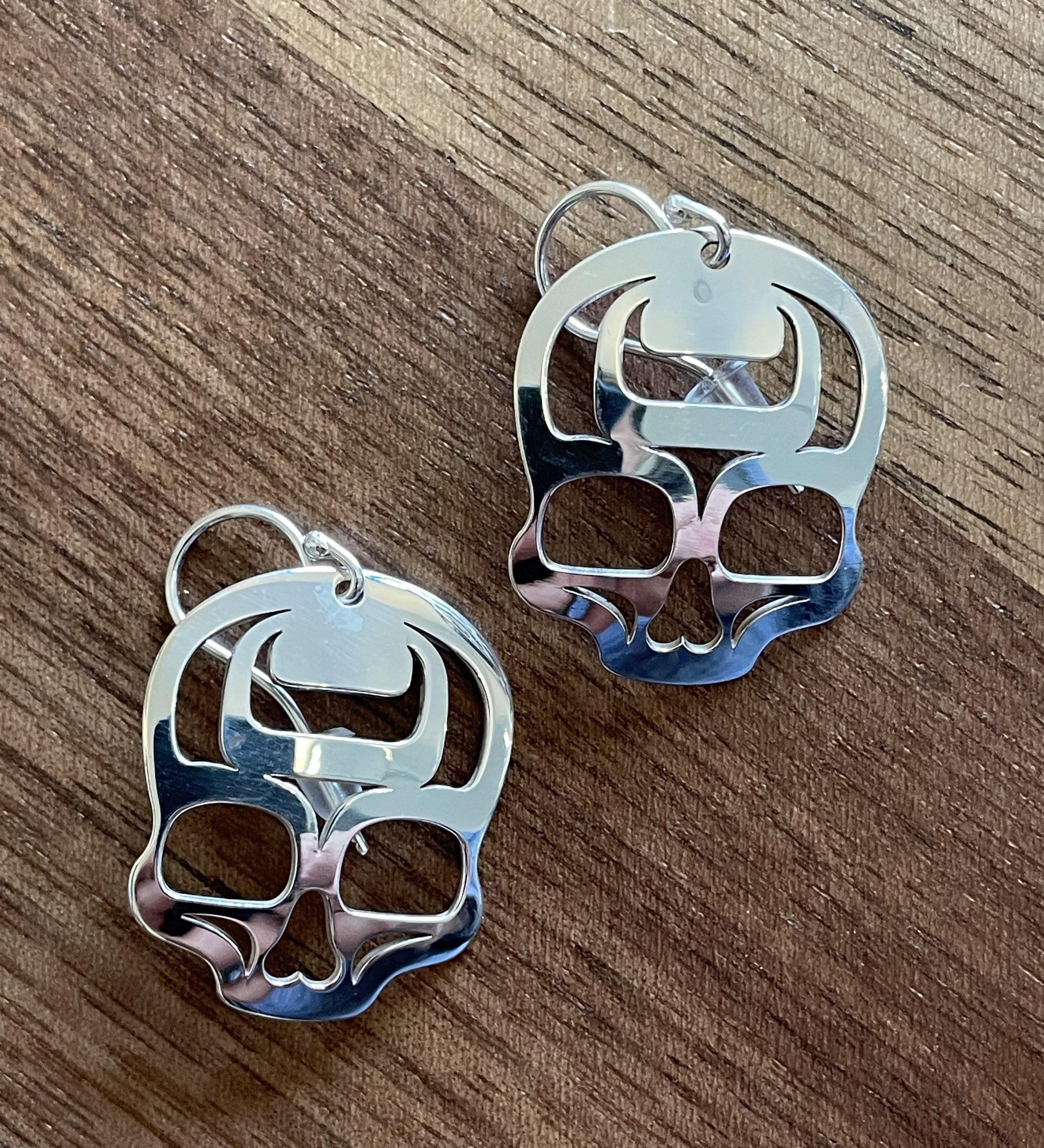 Close up of ancestral skull earrings by indigenous artist sterling silver