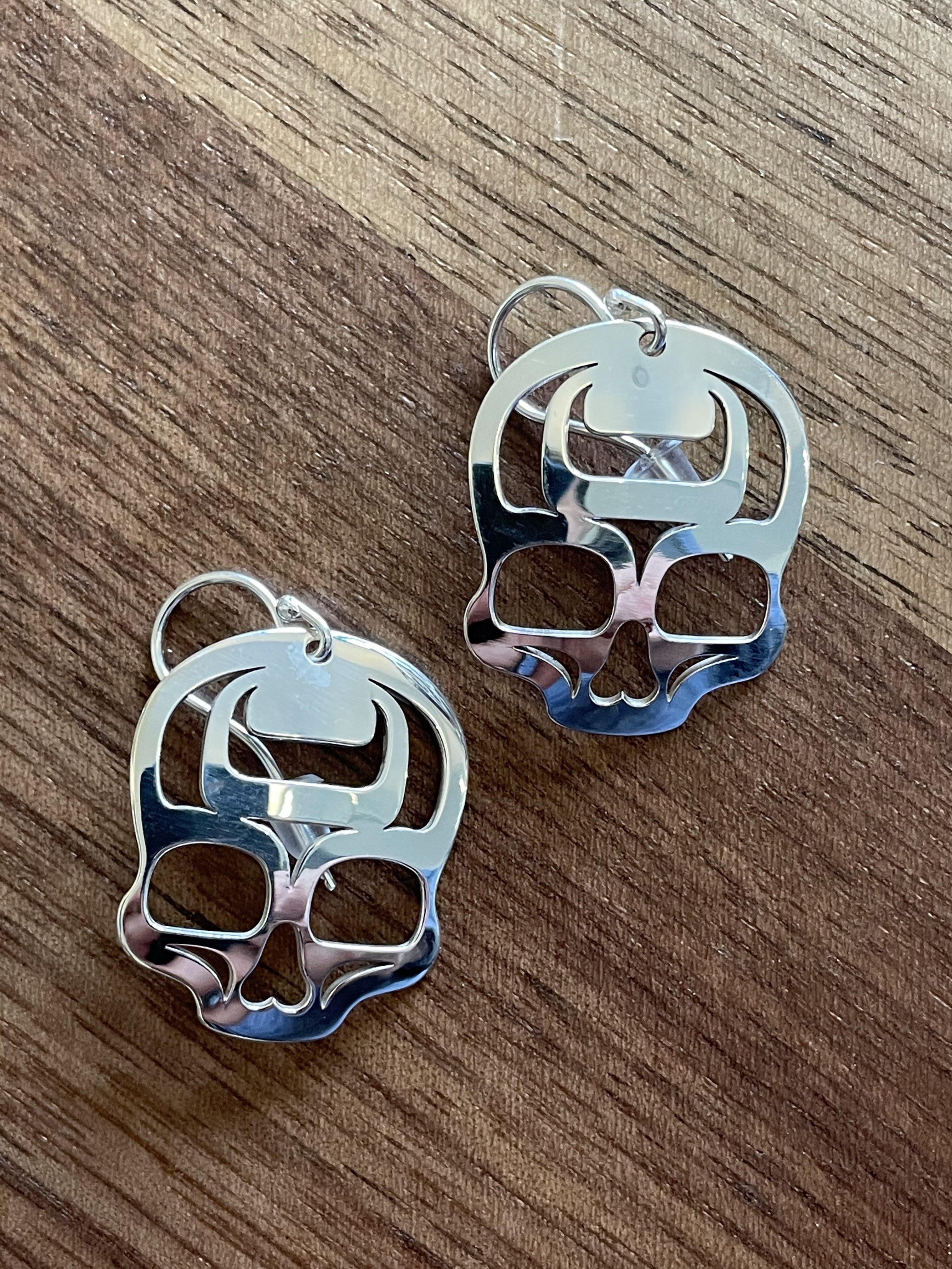 Close up of ancestral skull earrings by indigenous artist sterling silver