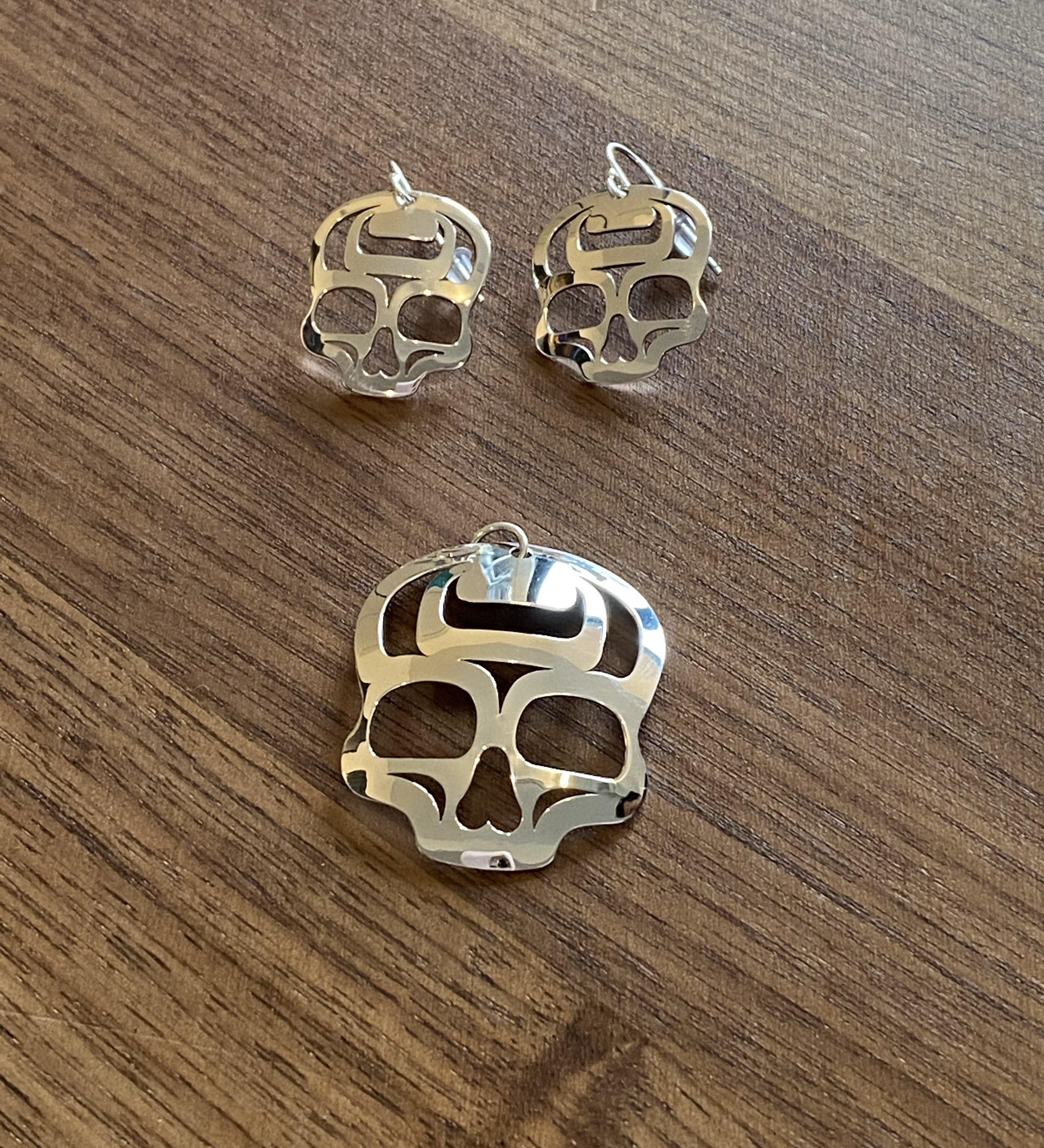 Close up of ancestral skull earrings by indigenous artist sterling silver 2