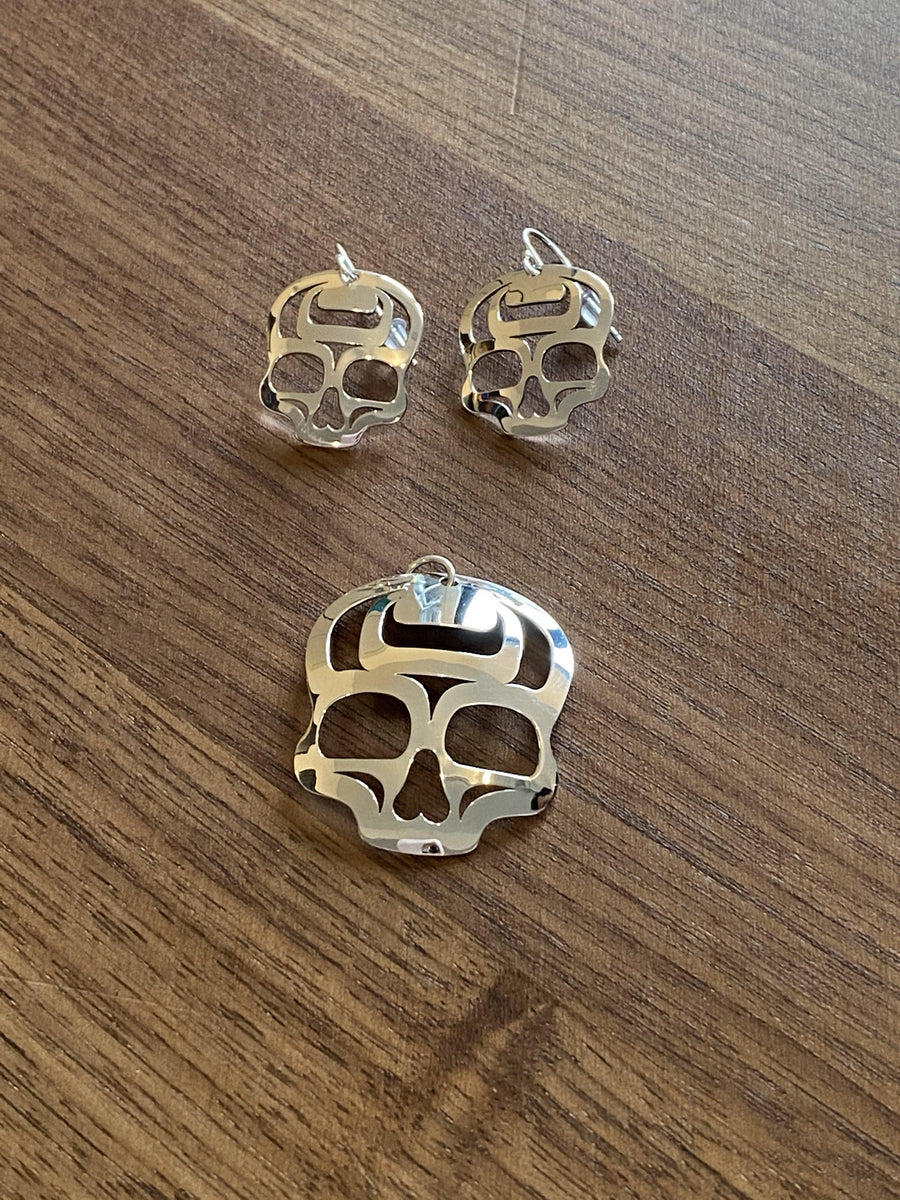 Close up of ancestral skull earrings by indigenous artist sterling silver 2