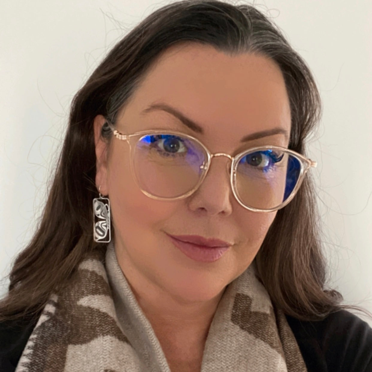 Model wearing butterfly earrings by indigenous artist silver