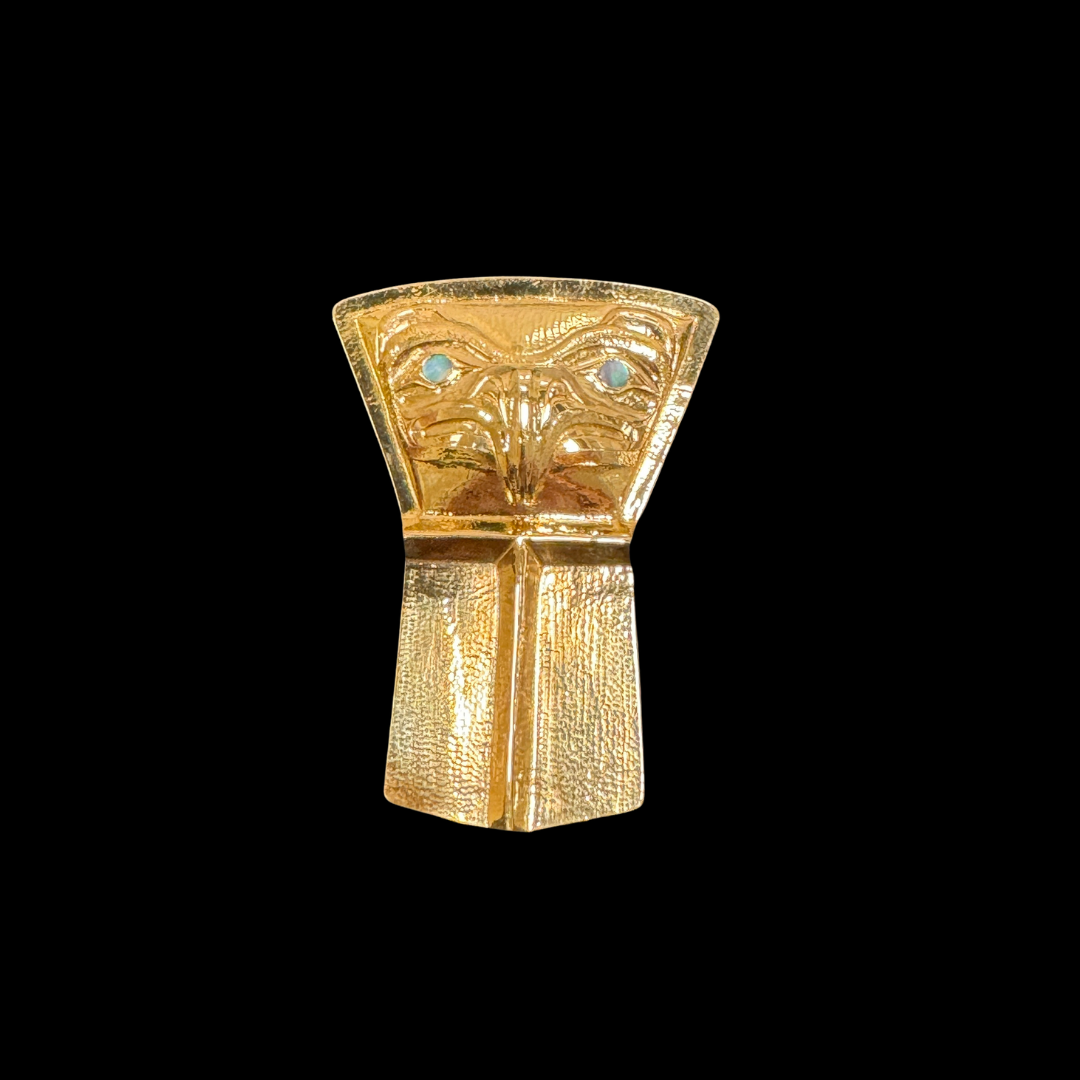Close up up of gold copper shield pendant by indigenous artist