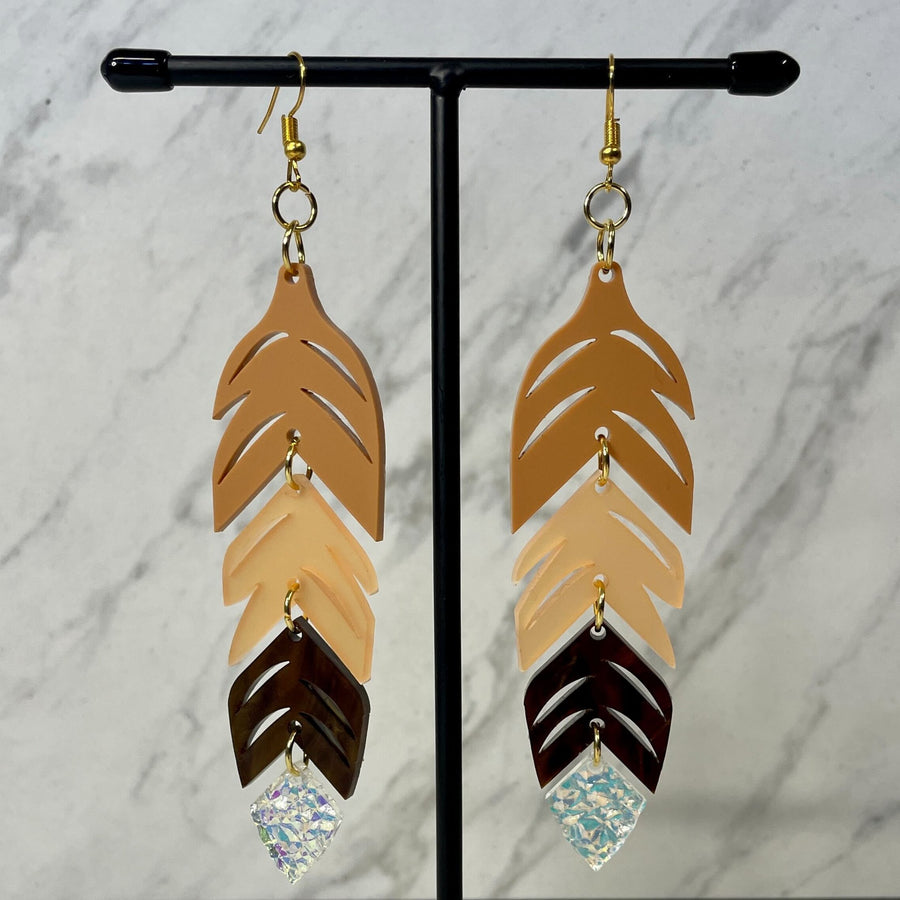 Close up up of dynamic tiered feather earrings by indigenous artist acrylic 3