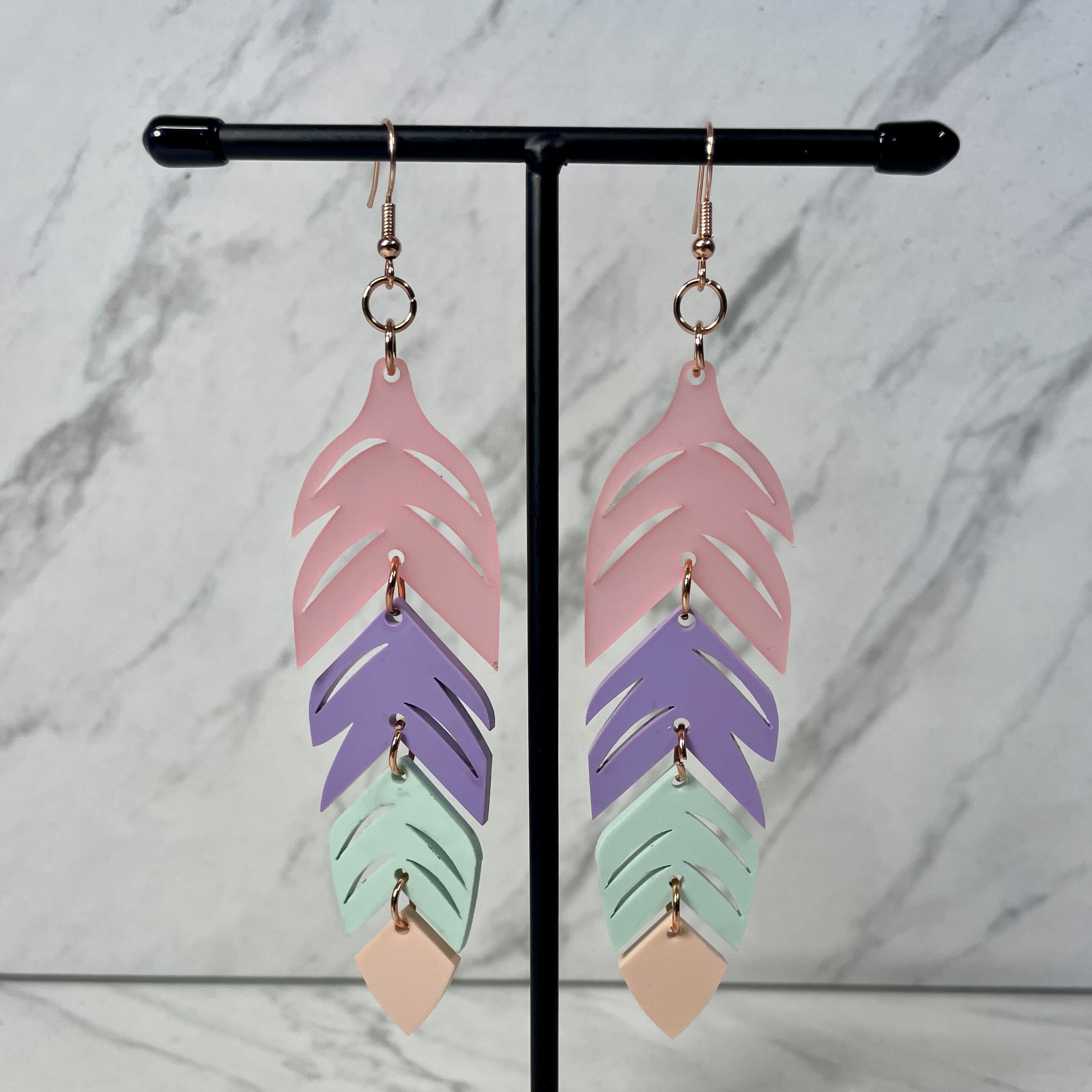 Close up up of dynamic tiered feather earrings by indigenous artist acrylic 5