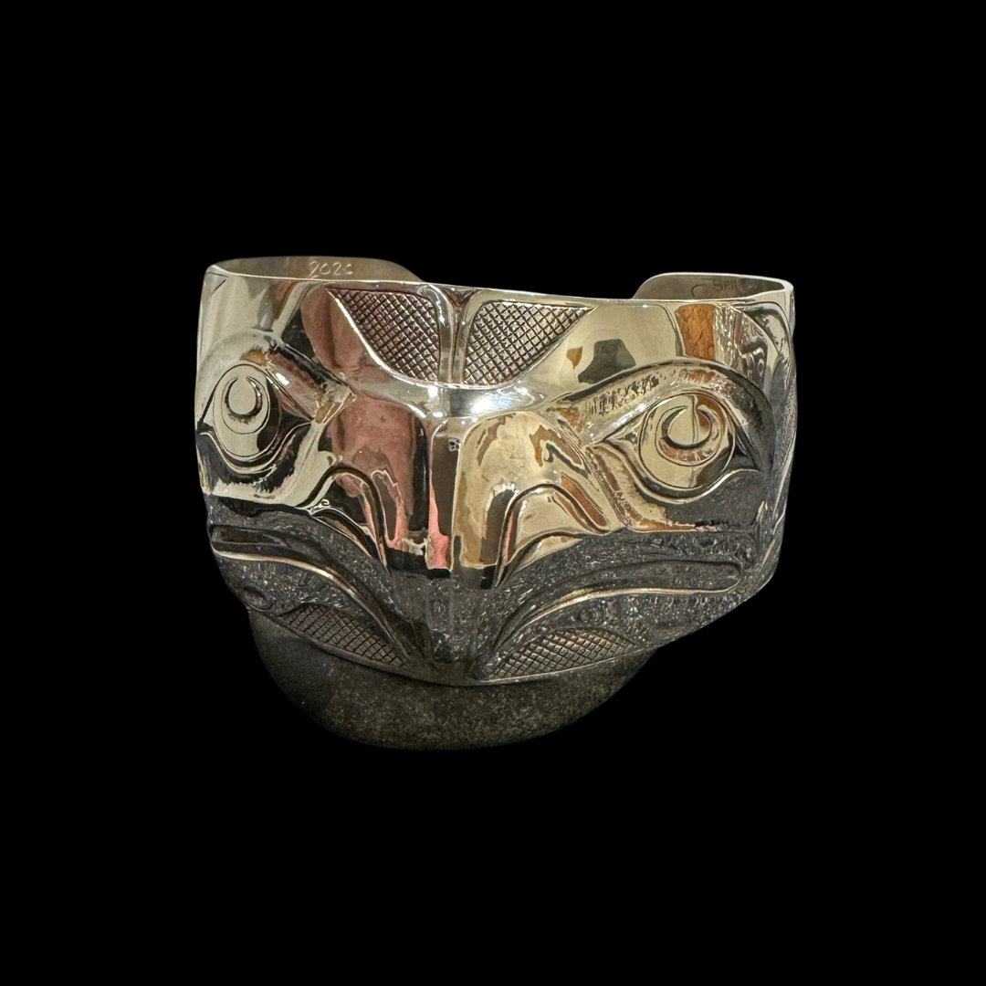 Close up up of eagle and salmon bracelet by indigenous artist