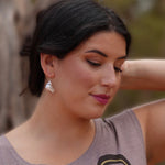 Model wearing earrings silver feather by indigenous artist