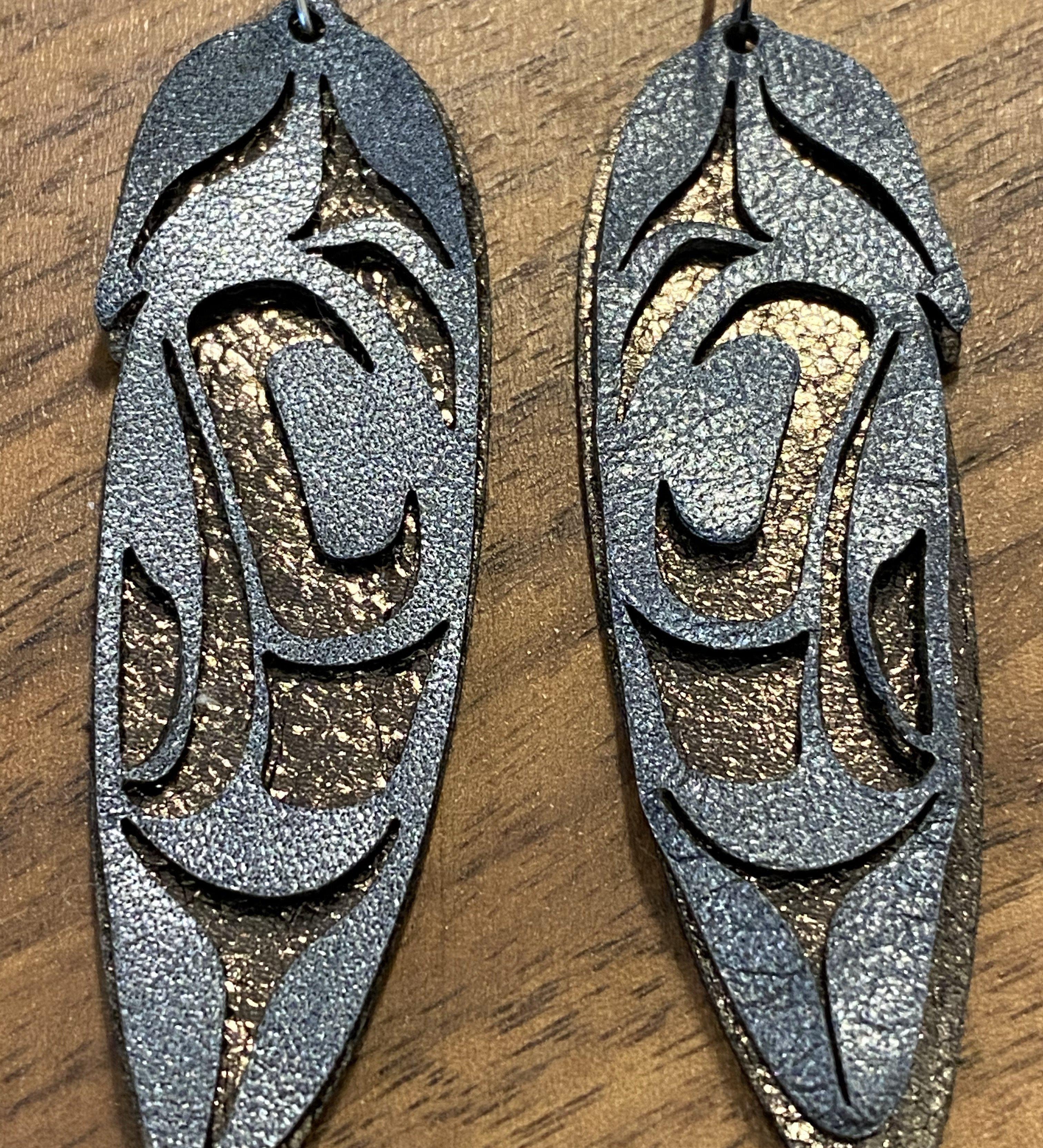 Close up of feather earrings by indigenous artist leather 2