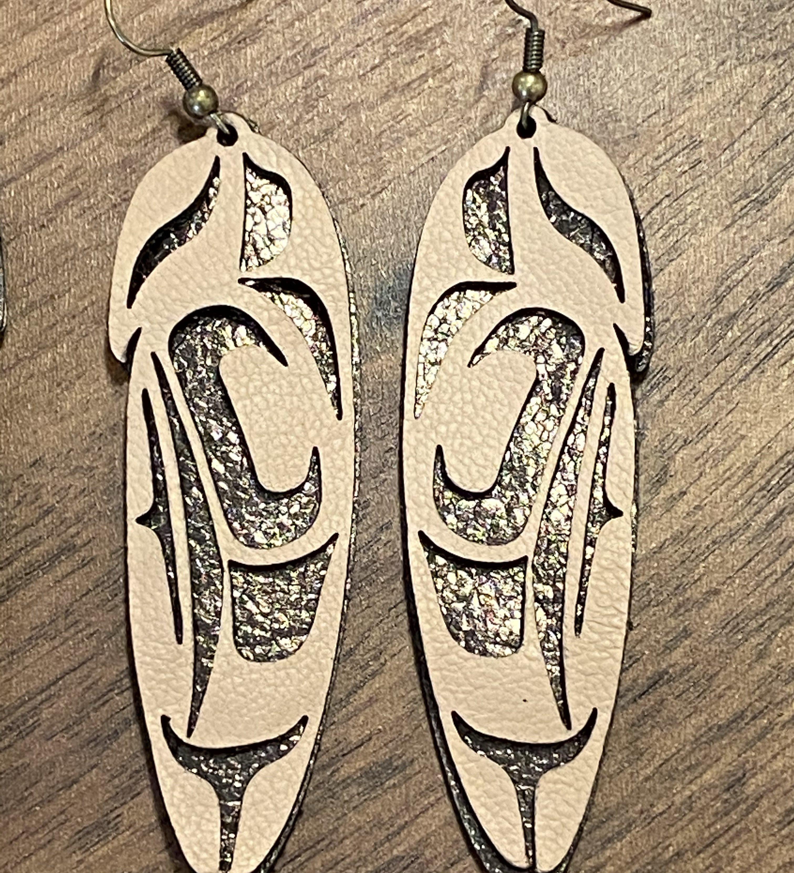 Close up of feather earrings by indigenous artist leather 3